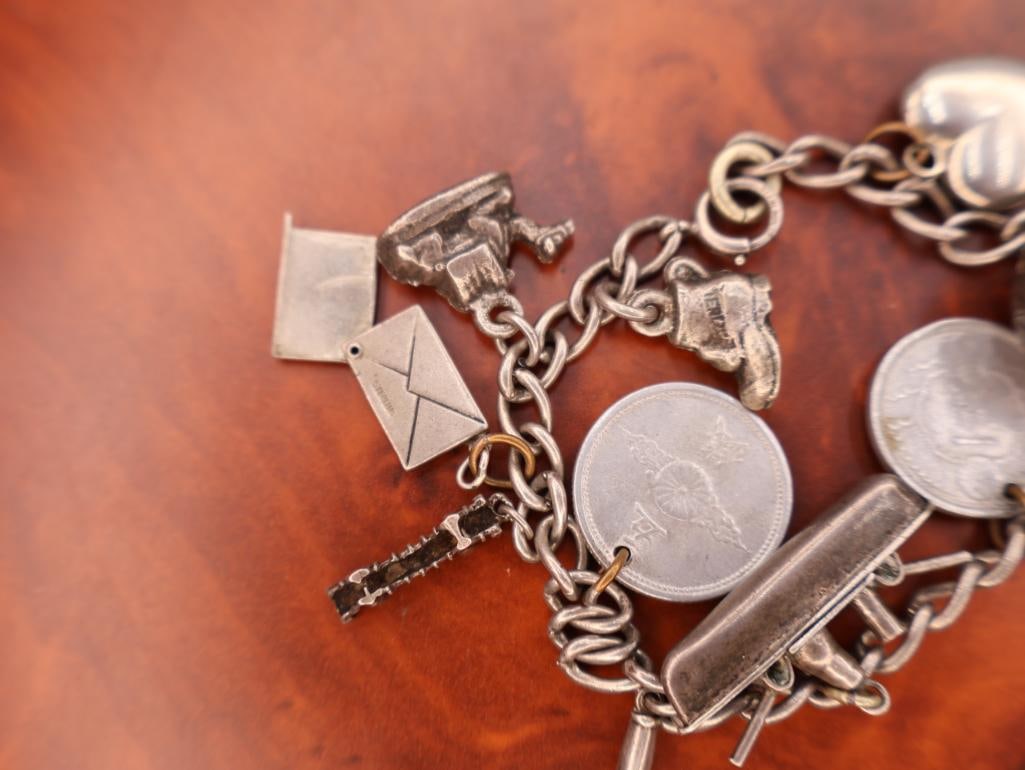 Vintage sterling silver charm bracelet with multiple charms - 6
