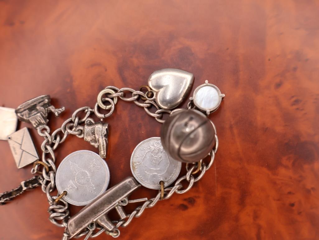 Vintage sterling silver charm bracelet with multiple charms - 8