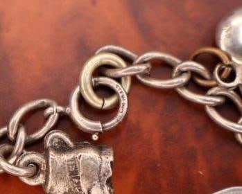 Vintage sterling silver charm bracelet with multiple charms - 9