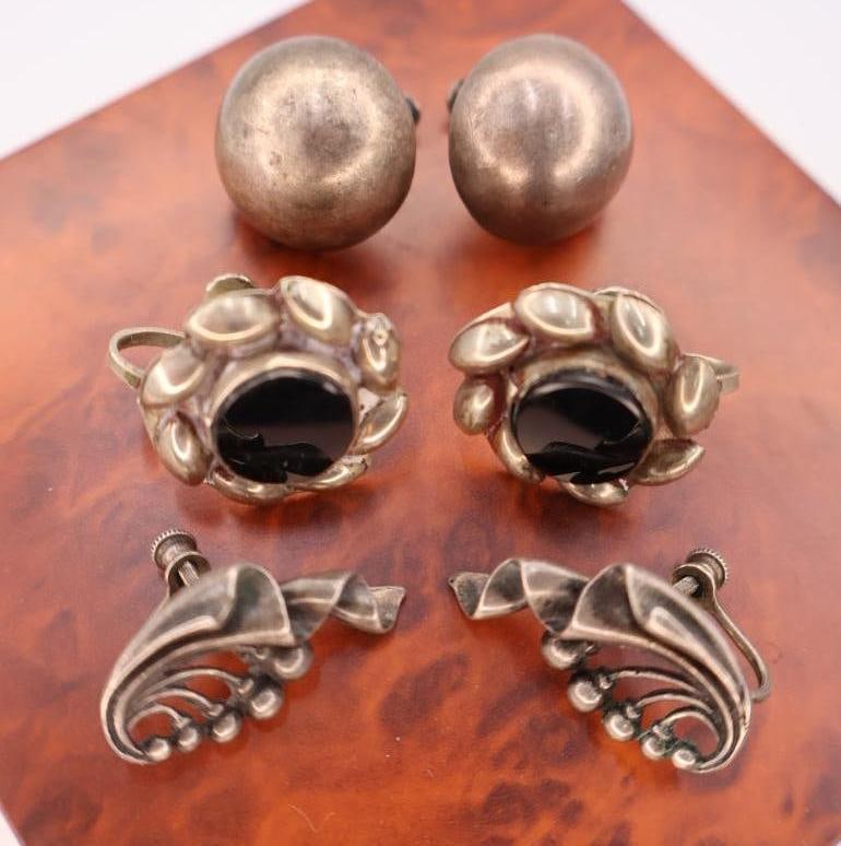Three pair of vintage screw back sterling silver earrings: These are vintage Mexican sterling silver earrings with black onyx stones. Click on the main photo to view more photos of this lot. Weight and length can be viewed in the photos. 