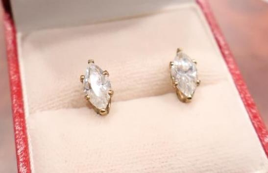 Pair of marquise-cut solitaire stud earrings set in gold: Total weight, 1.31 grams. Includes box, click on the main photo to view more photos of this lot. 