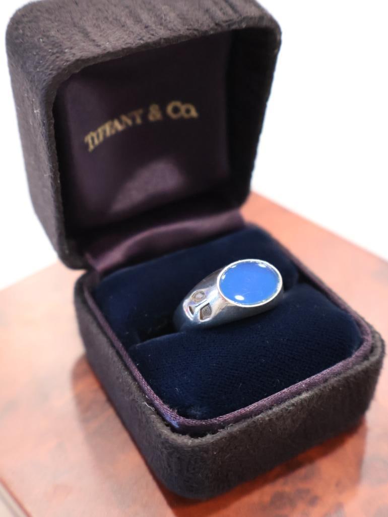 Tiffany & Co. Sterling Silver NASA Rockwell International Ring: It features a large, oval-shaped blue cabochon stonemost commonly identified as lapis lazuliset in a heavy signet-style mounting. Click on the main photo to view more photos of this lot. 