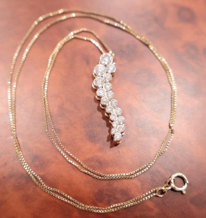 Diamond journey pendant necklace: 14k, Total weight 3.19 grams. A piece of symbolic jewelry typically representing life's progress or "journey" through a sequence of graduated stones. 