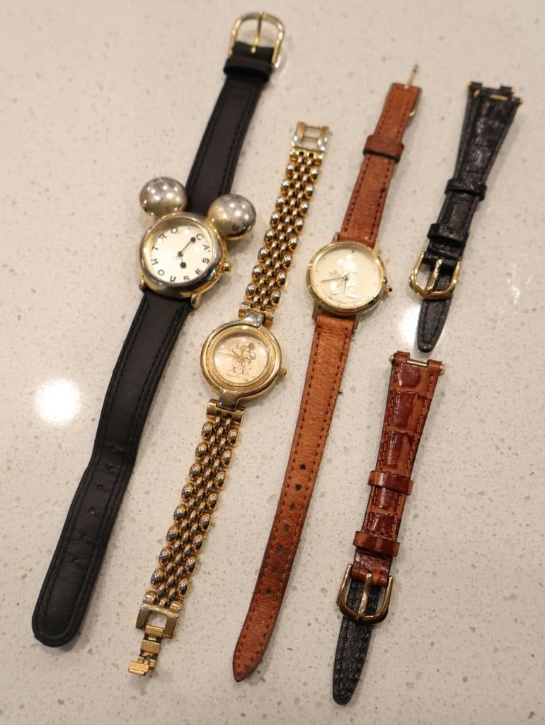Three Disney Mickey Mouse wristwatches: Includes a highly collectible "Cast Member" exclusive piece. A rare recognition gift for Disney employees, featuring a unique Mickey Mouse ear-shaped case and a silver-tone dial with "CAST MEMBER" let