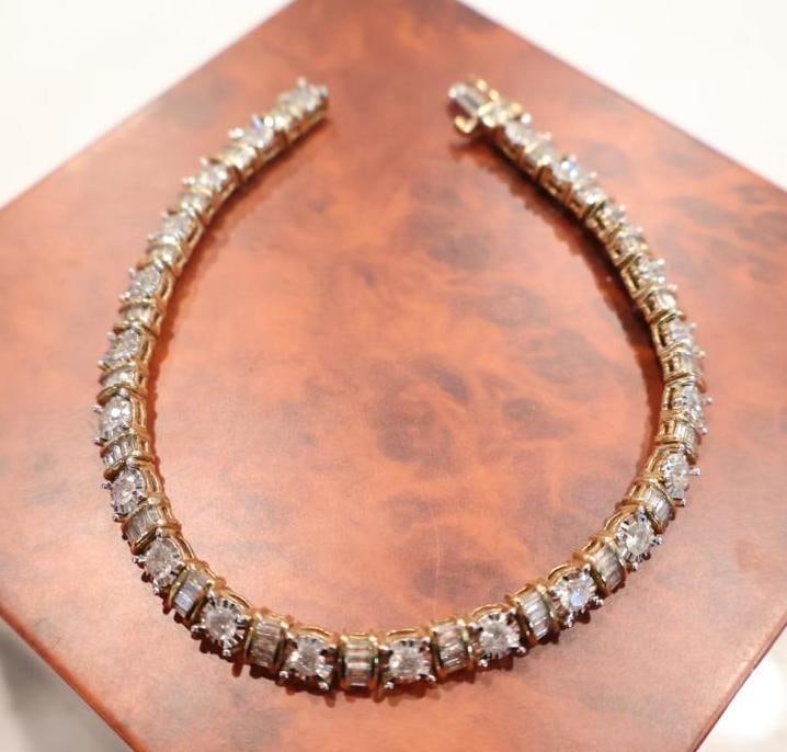 10k Gold 5 Cttw Diamond 7.5" Tennis Bracelet: Presented with its original box and protection plan documentation. A classic, continuous row of round-cut diamonds or high-quality lab-grown stones set in a flexible line. The included price tag
