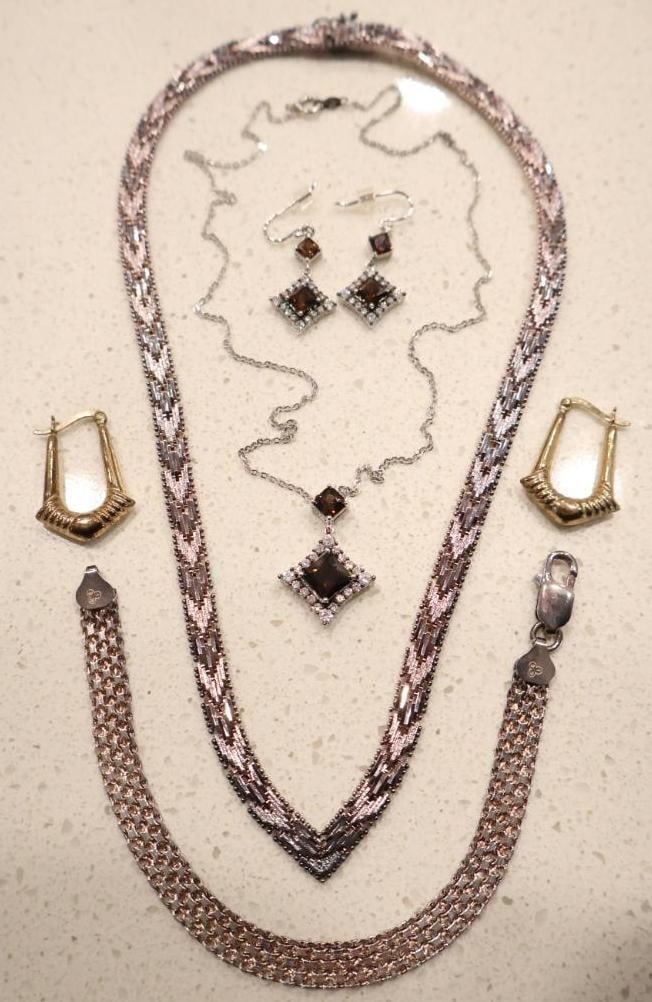 Collection of Sterling Silver Jewelry: Sterling ornate hoops, sterling garnet pendant with matching earrings, and sterling silver CZ flower earrings. Wide bracelet and necklace marked '925' but slightly magnetic 