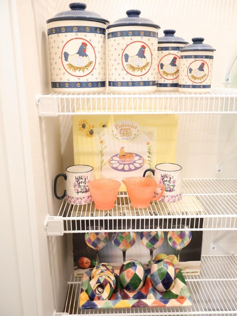 Curated collection of farmhouse-style kitchenware: Rooster & floral canister set, depression Glass, and vintage inspired mugs. 