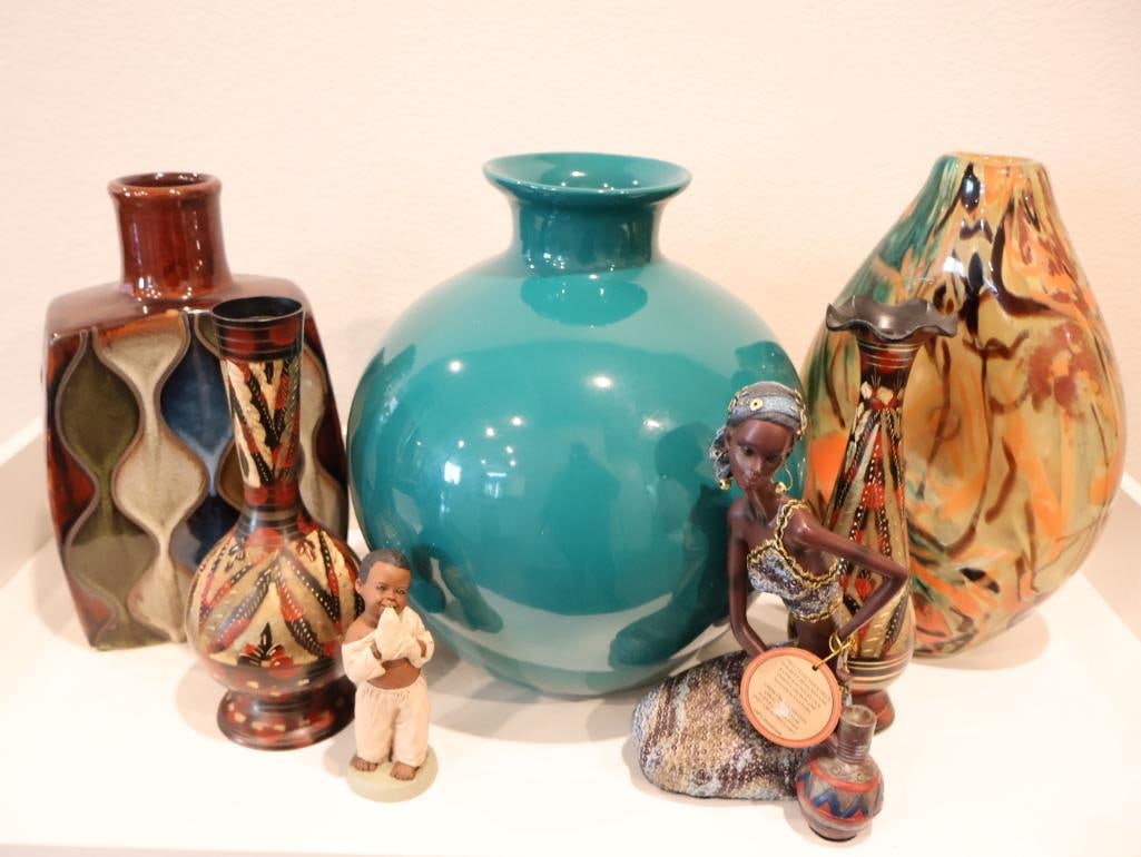 Eclectic collection of decorative items and Figurines: African female figurine, praying child figurine, and vases. 