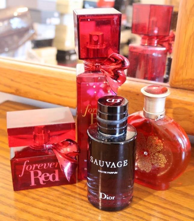 Collection featuring iconic scents from Dior, Bath & Body Works: A 100 ml bottle of Dior Sauvage Eau de Parfum, a signature men's fragrance known for its fresh, woody, and spicy profile. It features notes of bergamot, Sichuan pepper, and vanilla absolute. Forever