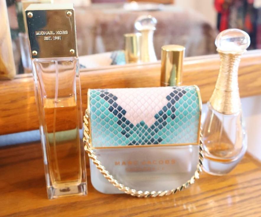 Collection of luxury perfumes: Marc Jacobs Decadence Eau So Decadent, Michael Kors Signature Collection, Dior J'adore and Marilyn Monroe