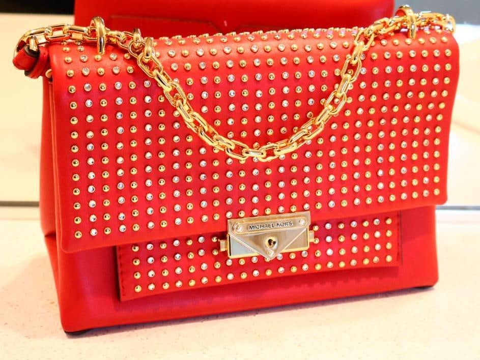 Red Michael Kors Cece Medium Studded Leather Shoulder Bag: Part of the Cece collection, it is designed for a blend of everyday elegance and a modern, slightly edgy aesthetic due to its stud and crystal embellishments. Features a structured silhouette adorned