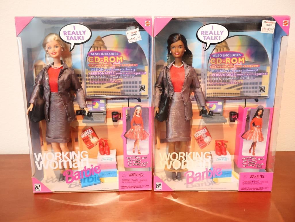 Two versions of the Working Woman Barbie: A special 1999 release from Mattel's career collection. The Working Woman Barbie was designed to represent the professional office style of the late 90s. It was the first Barbie to be packaged with