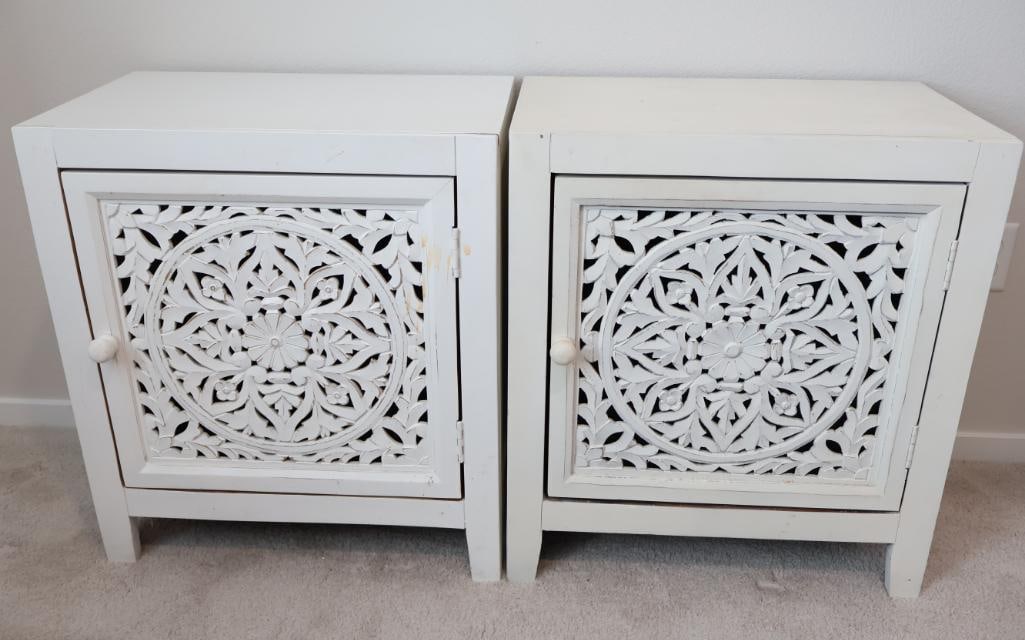 Pair of accent cabinets: These pieces feature a bohemian-inspired, hand-carved floral medallion pattern on a single door. AS-IS.