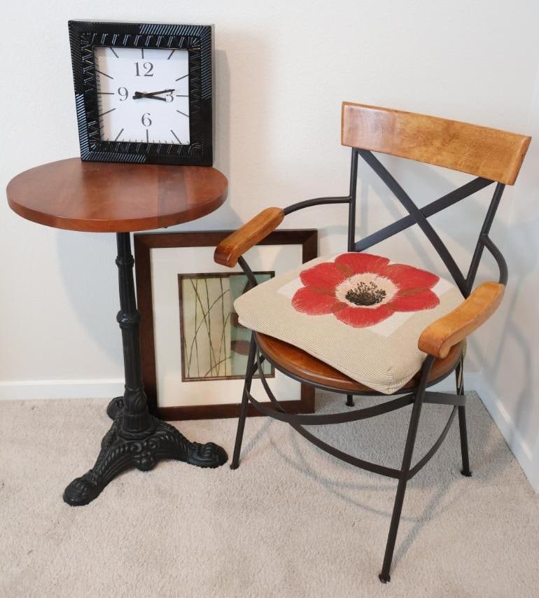 Mix of industrial and vintage-inspired furniture and decor: Deco 79 Metal Square Wall Clock: This 12" x 12" clock has a modern, minimalist design with a black metal frame featuring a distinctive, angular carved-look pattern. Brera Accent Table: Crafted by Caro