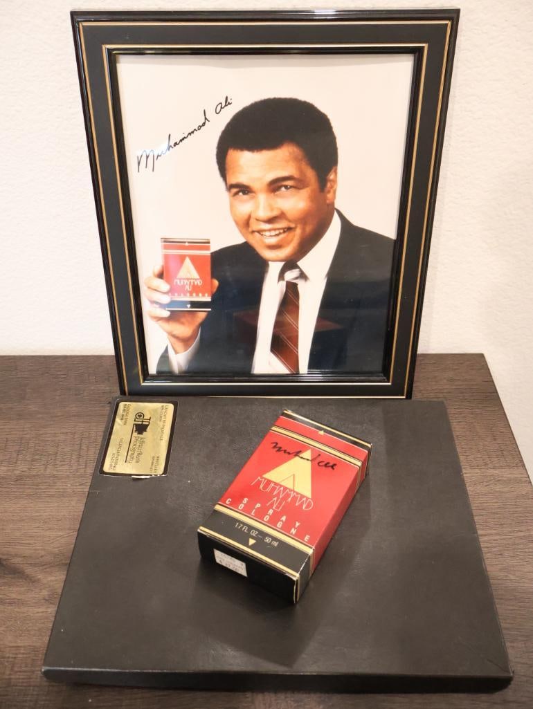 Personally Signed Muhammad Ali Cologne: Muhammad Ali Cologne 1988, personally signed on bottle and box. Includes two promotional prints, one in frame. 