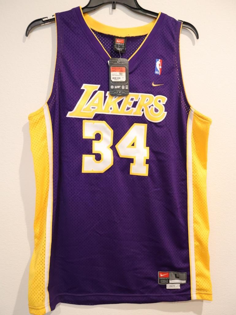 Official Nike Los Angeles Lakers Shaquille O'Neal #34 jersey: This is a vintage Nike Shaquille O'Neal #34 Los Angeles Lakers Swingman jersey in the team's iconic purple "Away" colorway. It represents the Lakers' legendary "Three-Peat" championship era from 2000