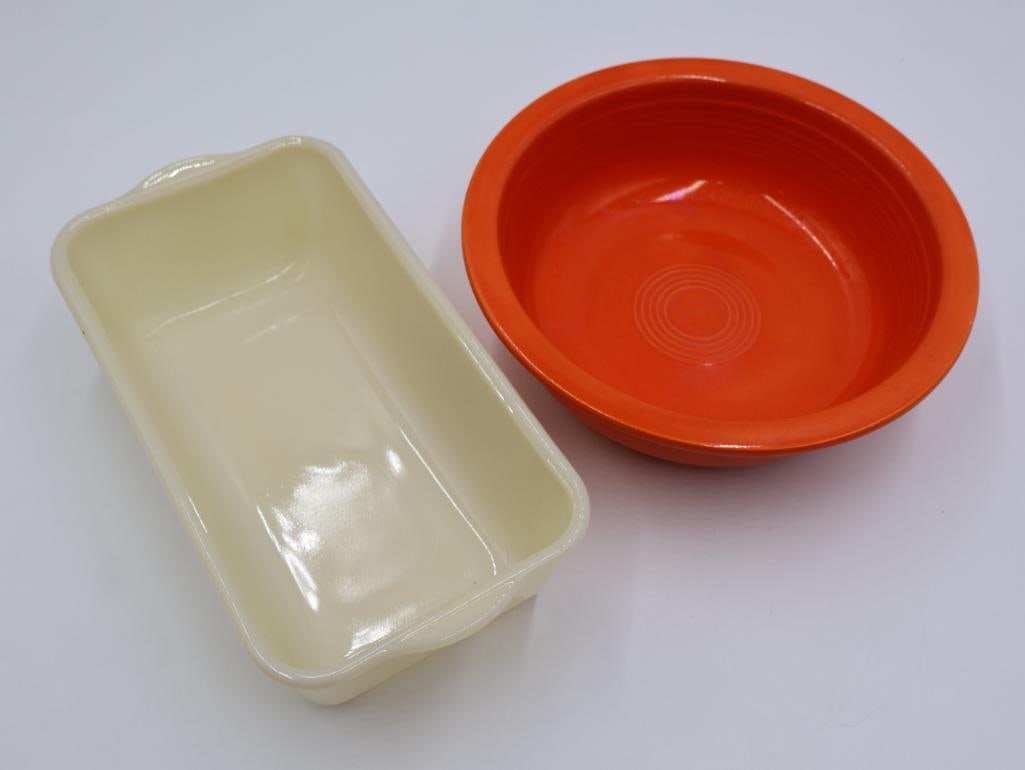 Vintage Vibrant Red-Orange Fiestaware Large Bowl and Fire King Glass Bread Pan: This vintage vibrant red orange Fiesta bowl is known for being radioactive. The lowercase 'fiesta' marking and the 'wet foot' completely glazed bottom of the bowl marks this as being made earlier when