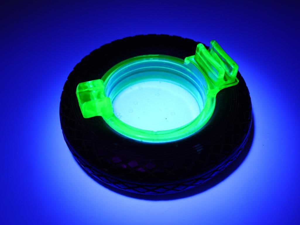 Vintage Green Uranium Glass Tire Ashtray: Vintage Goodyear Balloon tire, with black light sensitive green uranium glass ashtray with matchbox holder spot. Tire is slightly misshapen please see all photos