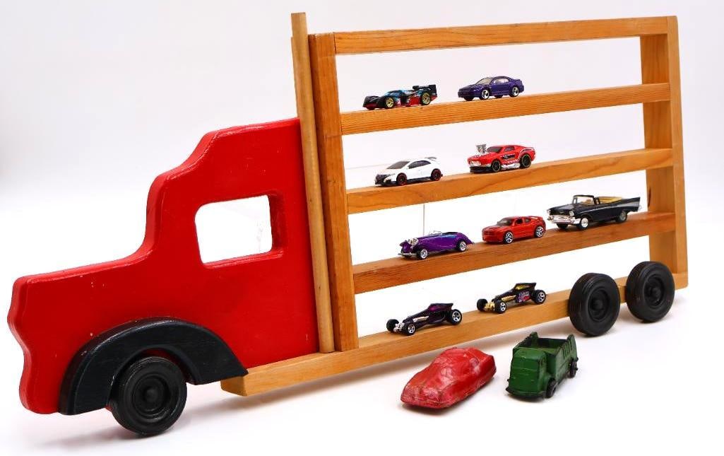 Wooden Truck Toy Car Display Rack and Various Hot Wheel and Vintage Toy Cars: Vintage hard rubber red Arcor car, green rubber Auburn USA truck, various hot wheels and more cars, and wall hanging wood haul truck to display toy cars