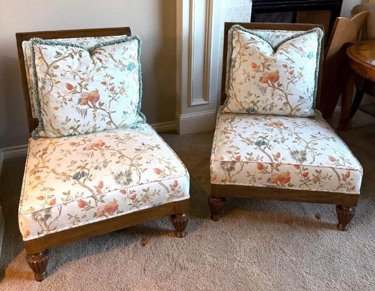 Beautiful Pair of Accent Chairs: Covered in exquisite light blue fabric with birds and flowers, each chair is adorned with an oversized matching fringed pillow