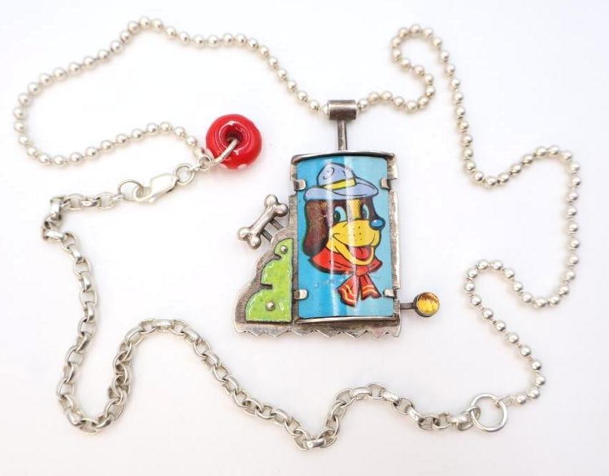 Sterling Silver 'Leader of the Pack' Artisan Mixed Media Necklace: Marked 'Leader of the Pack' .925, made by artist Chelsea Stone this piece features metal dog art most likely from a toy, enamel and other elements set in sterling silver on long silver chain