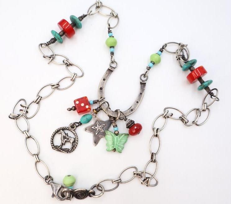 Artisan 'Lucky Horseshoe' Sterling Silver and Mixed Media Necklace: This western themed necklace features a mix of elements like stone and glass beads, vintage dice, and charms (one marked sterling silver). Clasp marked 925, necklace nonmagnetic