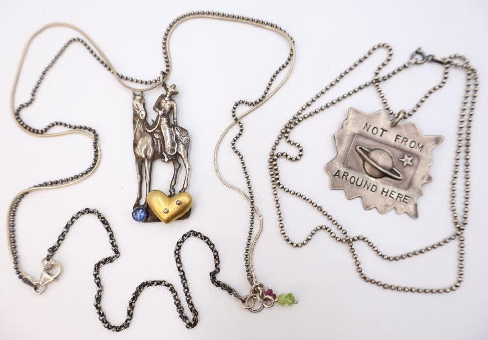 Two Sterling Silver and Mixed Media 'Worn' and 'Not From Around Here' Necklaces: Cowboy necklace is reminiscent of 'Worn' by Chelsea Stone but is unmarked, features multi strand sterling silver marked chains. Also includes 'Not from Around Here' marked Sterling silver pendant on