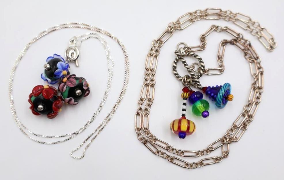 Two Glass Bead Necklaces on Sterling Silver Chains: Trio of Flower designed glass beans on marked 925 chain, and long sterling marked chain with three multicolored glass bead accents