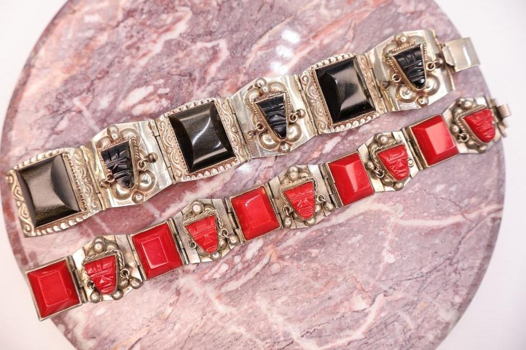 Pair of Vintage Southwestern Sterling Silver Bracelets with Black & Red Inlay Accents: Attractive pair of vintage Southwestern-style bracelets crafted in sterling silver and featuring striking geometric designs. One bracelet is accented with polished black stone panels and carved black