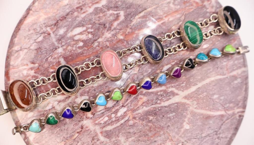 Pair of Sterling Silver Gemstone Bracelets Including Multi-Stone Link Bracelet: Attractive pair of sterling silver bracelets featuring an assortment of colorful semi-precious stone accents. The larger bracelet showcases oval cabochons including black onyx, malachite, lapis