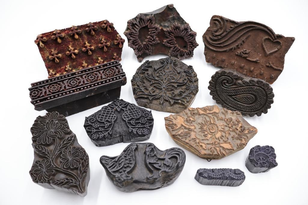 Assorted Antique Carved Textile Printing Blocks & Folk Art Stamps: Charming collection of antique carved textile printing blocks and decorative artisan stamps featuring floral, paisley, bird, and geometric motifs. Includes a variety of hand-carved wood blocks with