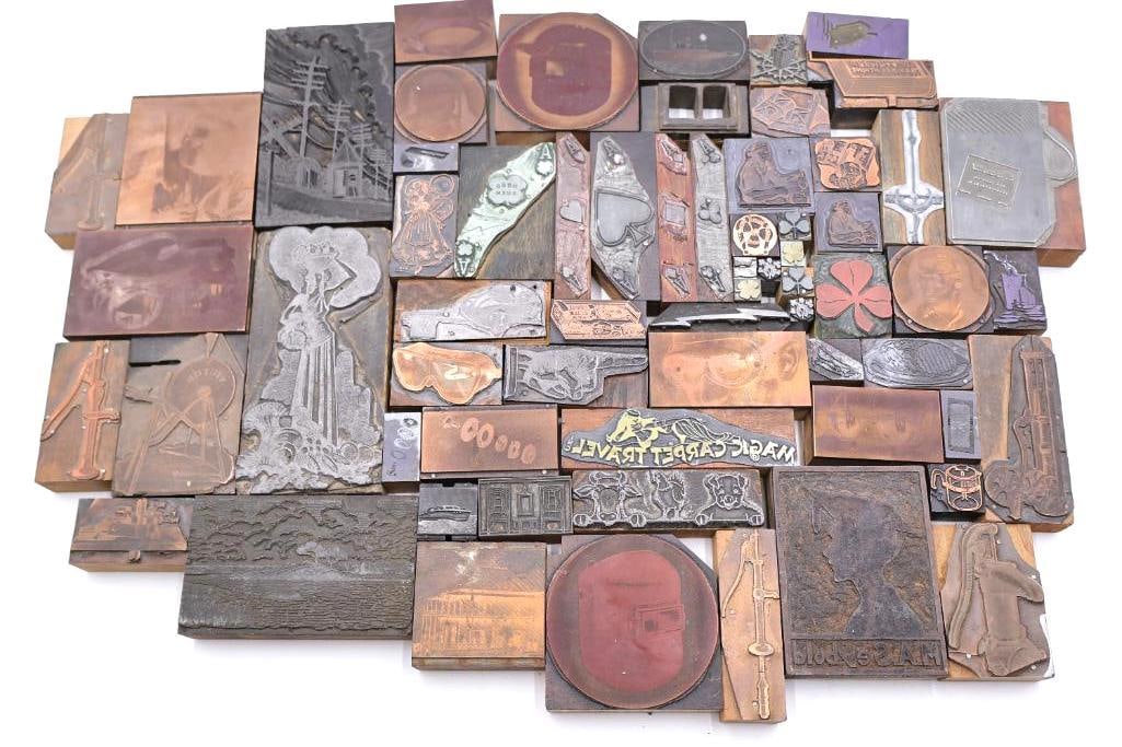 These are a collection of vintage letterpress printing blocks and copper cuts: The blocks feature a diverse mix of retro advertisements, illustrations, decorative borders, logos, and stylized text.