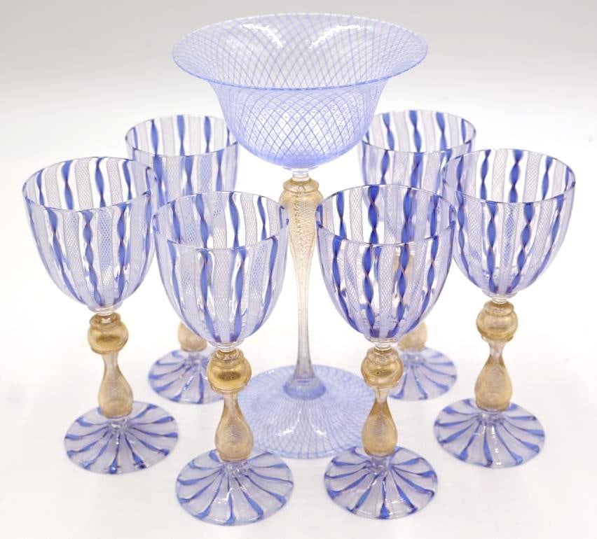 Fine Venetian Murano Filigrana Latticino & Aventurine Glass Goblet Set with Compote: The set utilizes traditional Venetian filigrana (latticino) techniques, specifically a retortoli caning method with blue stripes and avventurina (gold-tone) inclusions