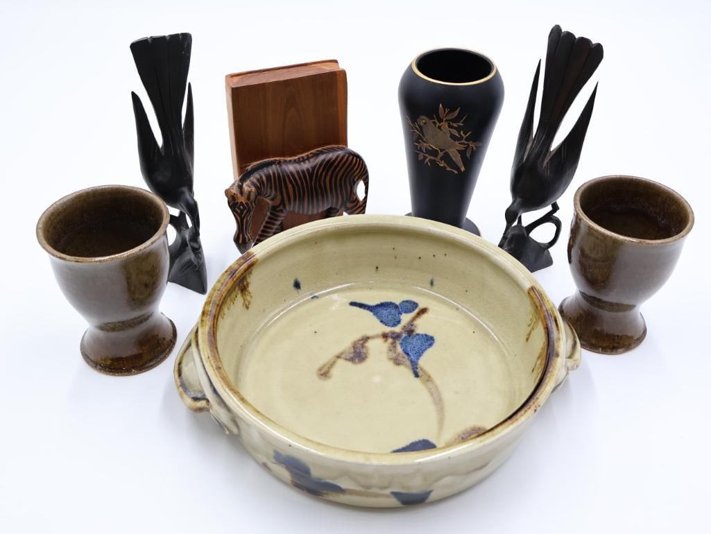 Vintage Stoneware and Wood Decor: Stoneware studio pottery bowl with unique handles, two goblets (one has chip on bottom), pair of wood carved birds, zebra wood bookend and black parrot vase