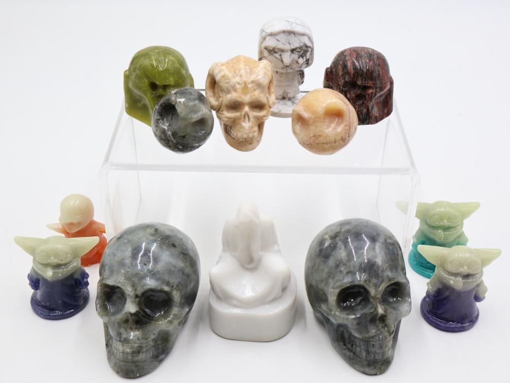 Collection of Pop Culture Carved Stone Figures and Molds: Various natural stone carving of skulls, hooded figure, Jack Skellington, the Mandalorian, and molded resin Baby Yoda and Charmander figures
