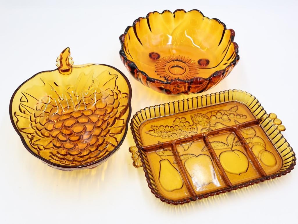 Three Amber Glass Serving Dishes: Large grape and flower serving bowls, and divided fruit themed platter