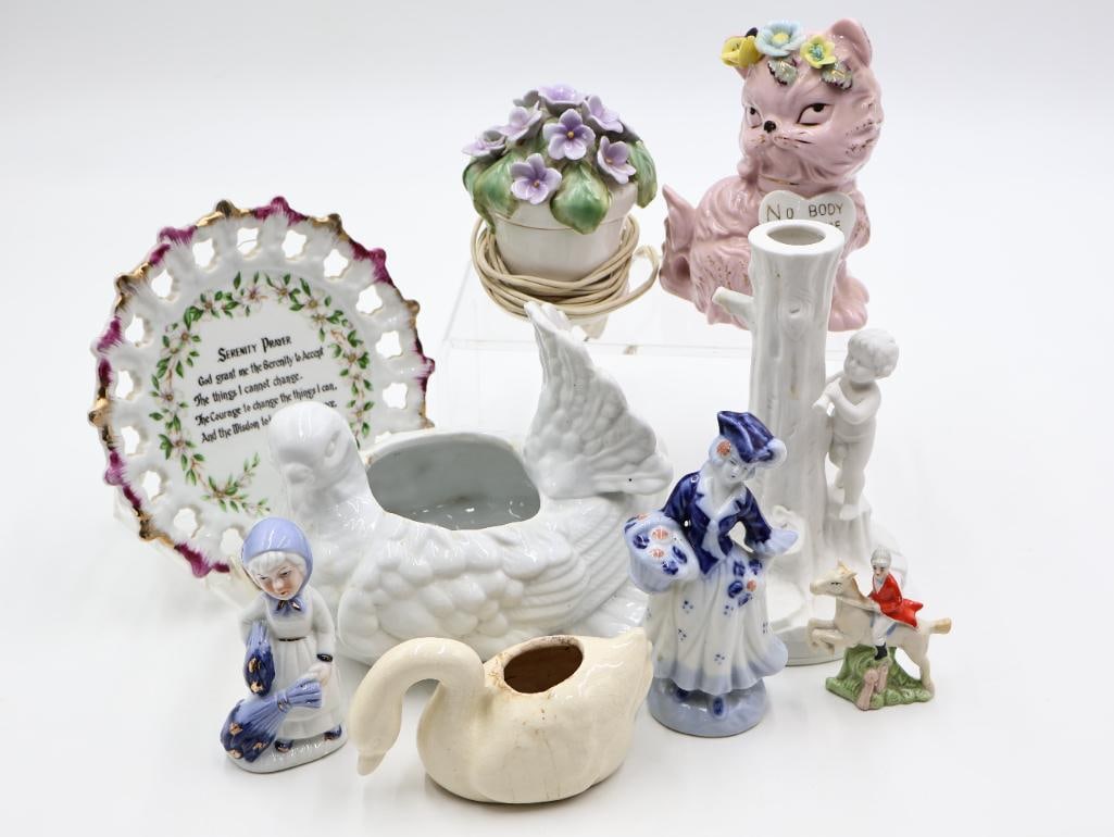 Various Vintage Ceramic Goods: Vintage glazed statues, bisque porcelain child and tree vase, Japanese 'Nobody Loves Me' car figure, and lighted flower small lamp