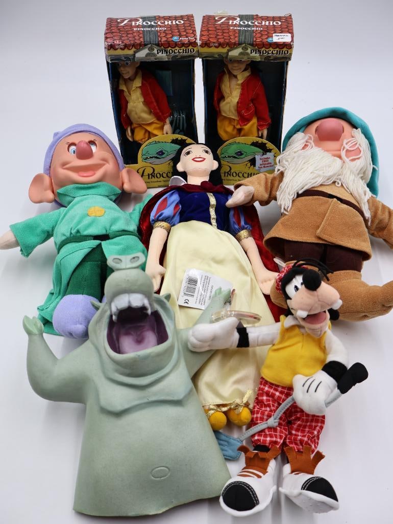 Various Disney Character Toys: Rubber Notre Dame gargoyle hand puppet, Goofy golfer plush, plush doll of Snow White, Sleepy and Dopey moving eyes dolls, and two in box The Adventures of Pinocchio dolls