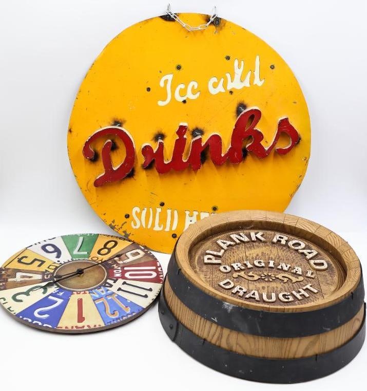 Three Advertising Wall Art: Faux barrel 'Plank Road Original Draught', printed license plate looking clock, and large 23.5" diameter Ice Cold Drinks Sold Here sign