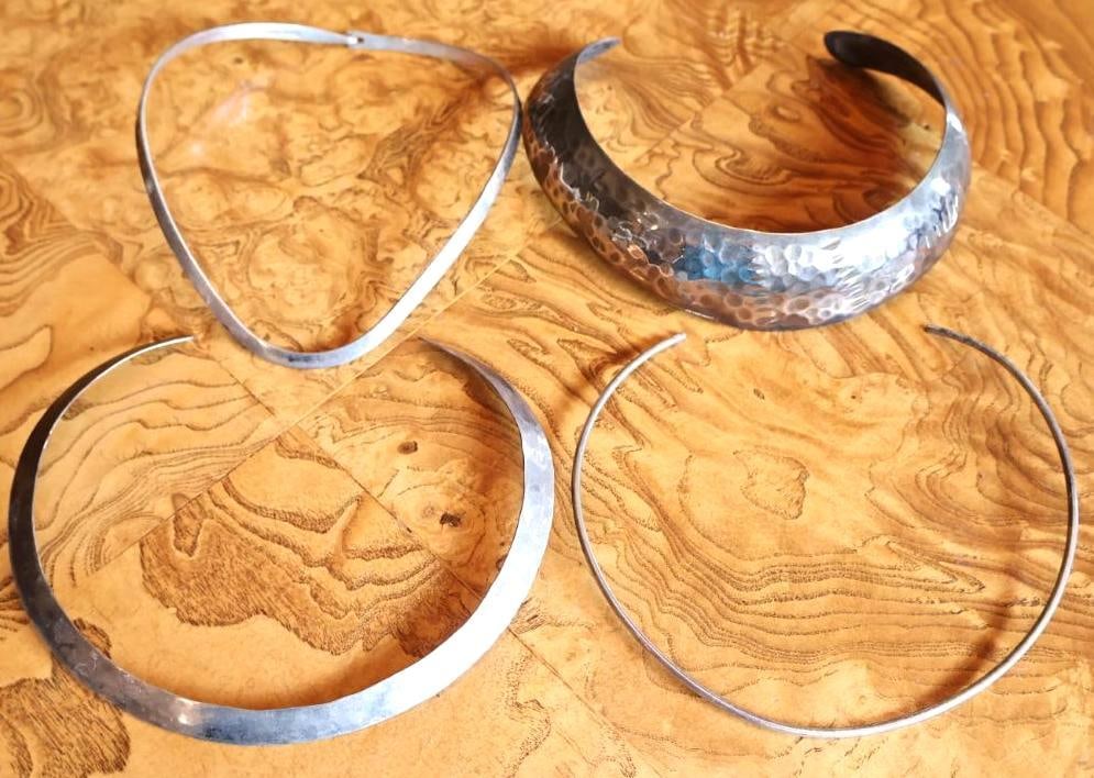 Four Modernist Silver-Tone Collar Necklaces, Two Sterling: Collection of four vintage modernist collar/choker necklaces, including a wide hammered crescent design and three slender curved examples. Two pieces are marked STERLING / 925 STERLING; remaining two