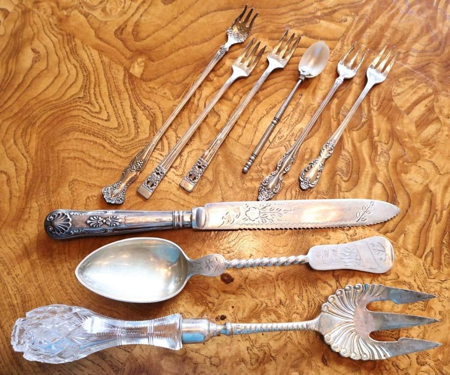 Antique & Vintage Serving and Flatware Assortment: Mixed flatware assortment featuring serving pieces, cocktail forks, mother-of-pearl spoon, cut-glass handled fork, and engraved serving knife. Pieces bear assorted hallmarks and have not been