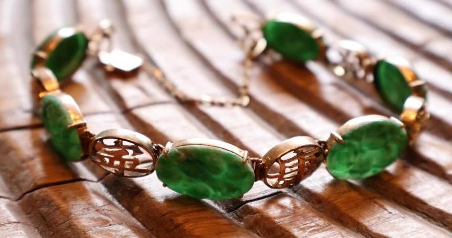 Vintage 14K Gold Green Stone Link Bracelet, Jade-Style Cabochons: Vintage link bracelet featuring oval carved/mottled green stone cabochons alternating with openwork 14K gold links. Clasp component marked 14K and PAT. 1652356, with attached safety chain. Green