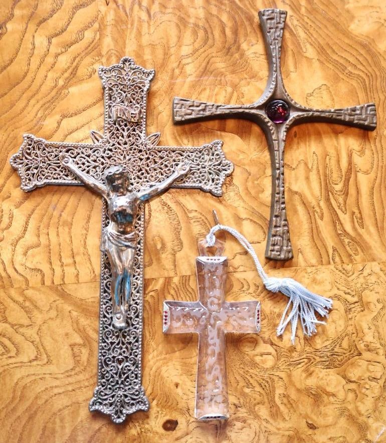 Three Decorative Crosses & Crucifix Glass and Metal: Group of three Christian devotional crosses, including a large ornate filigree metal crucifix with applied figure of Christ, a textured metal cross with purple glass cabochon, and a decorative clear