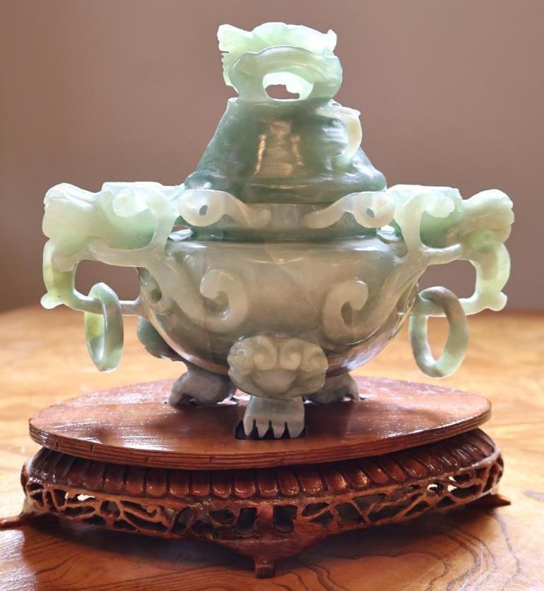 Chinese Carved Green Hardstone Covered Censer, Dragon Handles and Stand: Chinese carved green hardstone covered censer with pierced dragon-form decoration, loose ring handles, animal-form feet, and fitted carved wood stand. Approx. 7" H including stand. Stone untested,