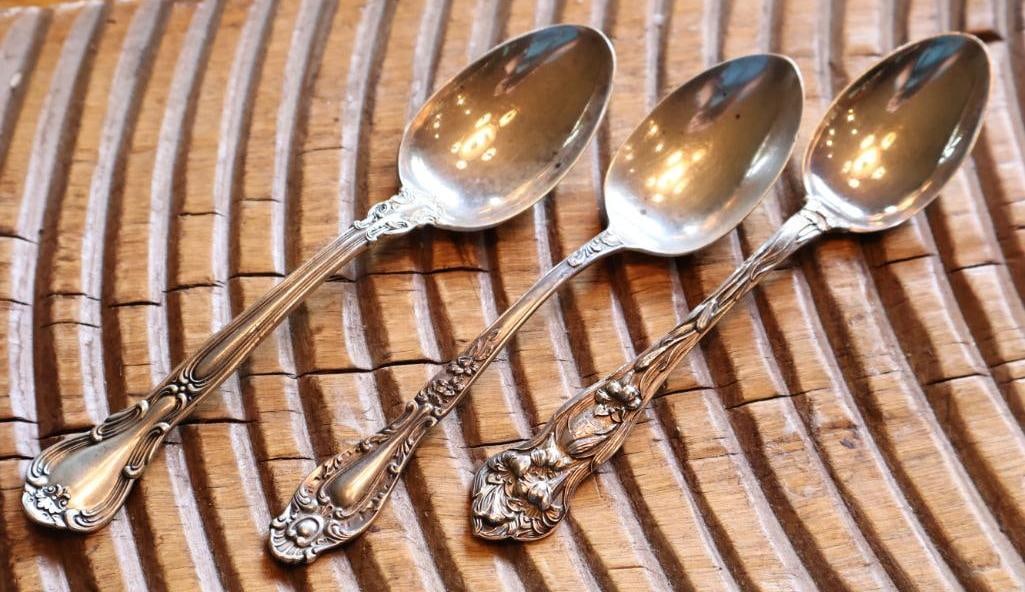 Lot of 3 Antique Sterling Silver Serving Spoons Ornate Patterns, 76g: Group of three sterling silver serving/table spoons in assorted ornate patterns, including floral and scrollwork designs. Each piece is marked Sterling. Combined weight approximately 76 grams. Mixed