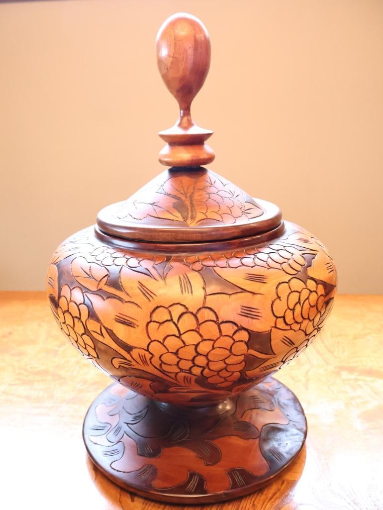 Large Hand-Carved Floral Wood Covered Urn / Decorative Vessel, 17": Large hand-carved wooden covered urn or decorative vessel featuring a rounded body richly carved with oversized floral and foliate motifs in contrasting warm brown tones. Raised on a broad circular
