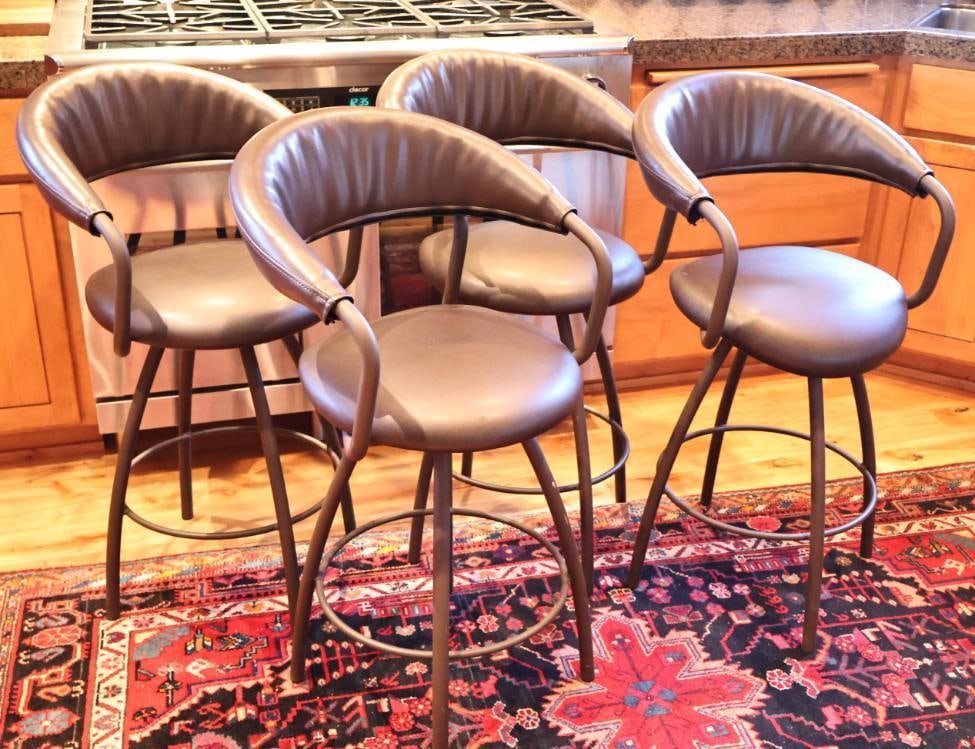 Set of 4 Contemporary Black Upholstered Bar Stools: Sleek modern design suitable for a kitchen island, bar, or entertainment area. Each measures approximately 38" H x 22" W. Overall good pre-owned condition with normal surface wear from use, including