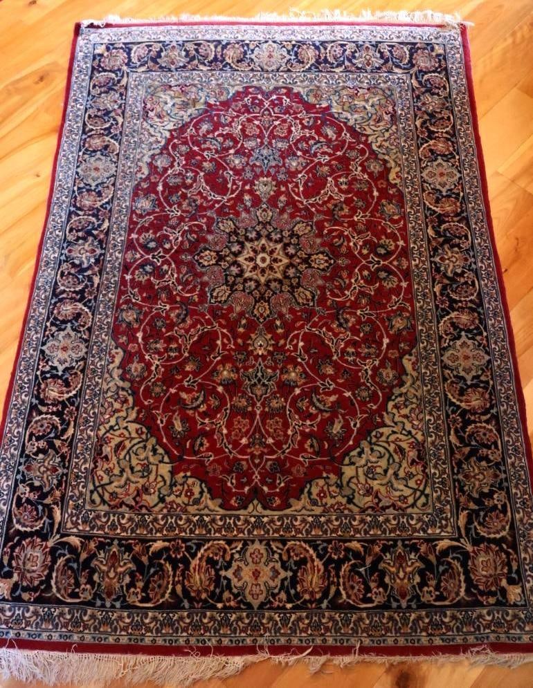 Persian-Style Floral Medallion Area Rug, Red and Navy: Traditional Persian-style area rug featuring an ornate central floral medallion surrounded by scrolling floral and foliate motifs. Measures approximately 65" x 43" (5'5" x 3'7"). Pre-owned condition
