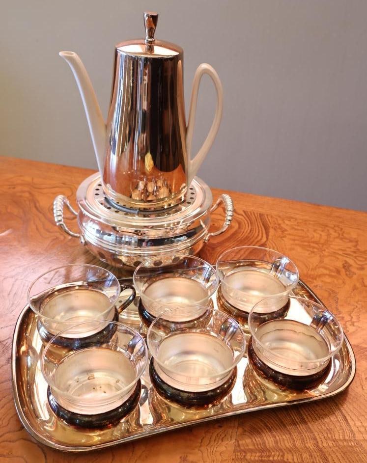 Vintage HKE Porcelain and Chrome Coffee Service Set: Vintage coffee service featuring a sleek chrome-tone coffee pot with white porcelain handle and spout, coordinating warming stand/burner, and serving tray. Porcelain component bears an HKE mark with