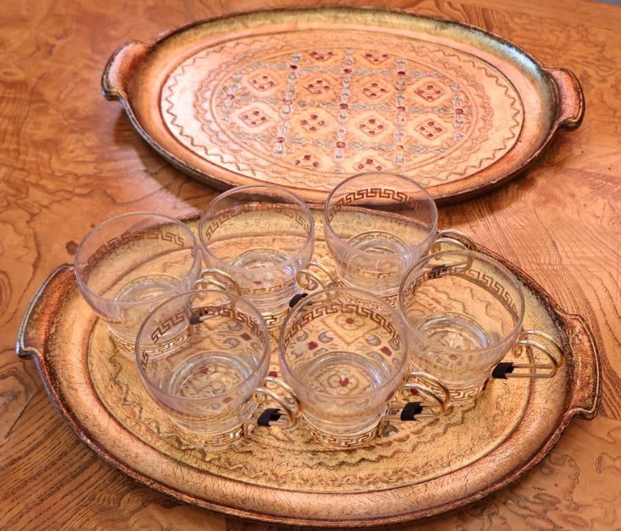 Vintage Hollywood Regency Greek Key Glass Cups and Florentine Gilt Serving Trays: Great Hollywood Regency / Mid-Century entertaining look. Vintage pre-owned condition with expected wear, patina, finish loss and surface marks to the trays and some wear to the gold decoration on the